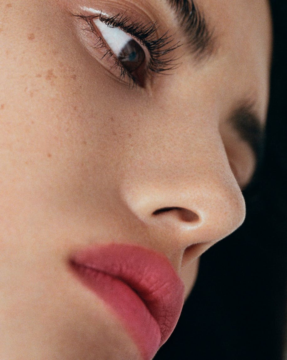 close up of model's profile wearing generation g in punch on lips